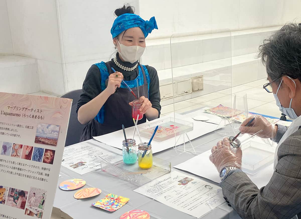 静岡県障害者芸術祭でのマーブリングアートワークショップ絵の具を持っている様子